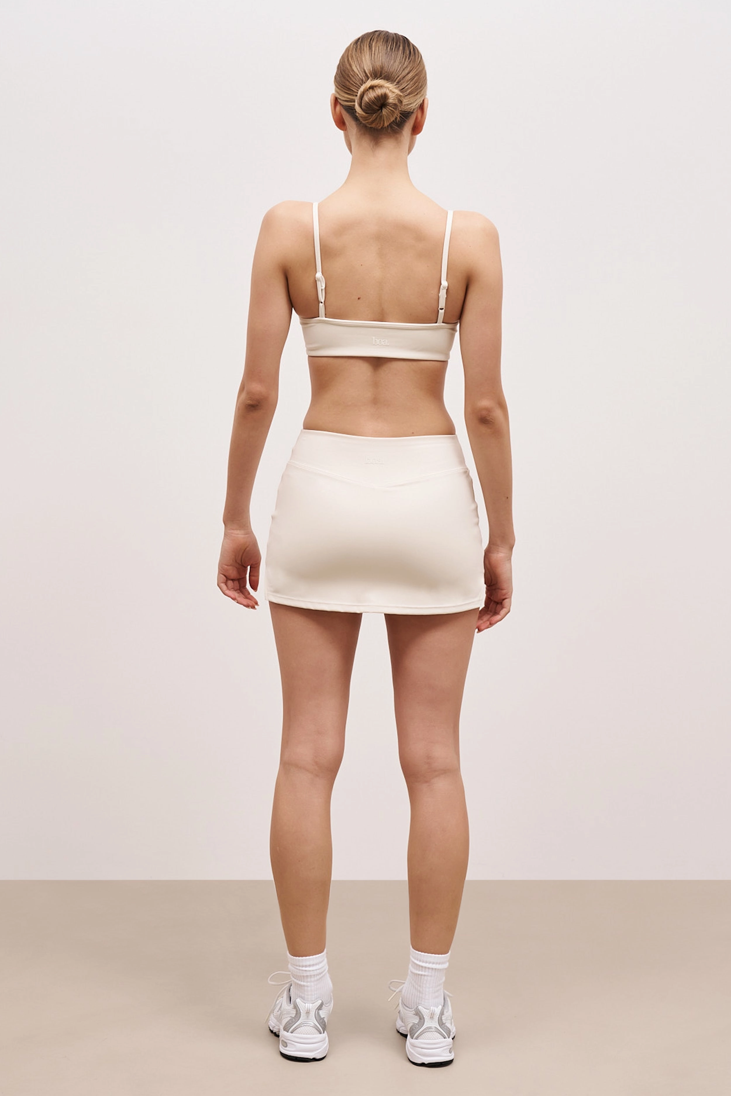 Base Sculpting Tennis Skort - Tofu Reflective Trim Details
